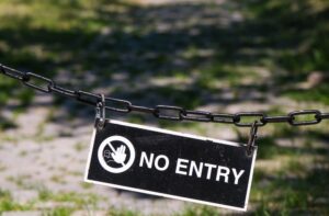 Old black and white sign with warning symbol representing the concept of Premises Liability