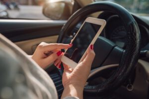 Woman distracted with her phone while driving